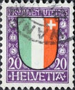 Switzerland - Circa 1923: a postage stamp printed in the Switzerland showing a green, white red coat of arms with a white cross of