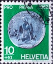 Switzerland - Circa 1962 : a postage stamp printed in the swiss showing an ancient coin. Half a silver coin Oberwalden national ce