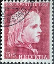 Switzerland - Circa 1953 : a postage stamp printed in the swiss showing a portrait drawing of a girl`s head by Albert Anker