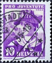 Switzerland - Circa 1934 : a postage stamp printed in the swiss showing the portrait of a Valais woman in historical costume in th