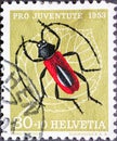 Switzerland - Circa 1953 : a postage stamp printed in the swiss showing a red beetle called purple buck Purpuricenus kaehleri on a