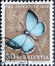 Switzerland - Circa 1952 : a postage stamp printed in the swiss showing a silver-gray blue butterfly Lycaena argentata on mounta