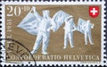 Switzerland - Circa 1951 : a postage stamp printed in the swiss showing three traditional flag throwers in costume..The coat of ar