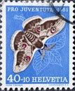 Switzerland - Circa 1951 : a postage stamp printed in the swiss showing a Viennese night peacock butterfly Saturnia pyri on a pe