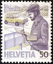 SWITZERLAND - CIRCA 1986: A stamp printed in Switzerland shows postman and mail handling, circa 1986.