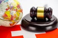 Switzerland flag and Judge hammer with globe world map. Law and justice court. Royalty Free Stock Photo