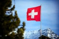 Switzerland flag Over Swiss Mountains Royalty Free Stock Photo
