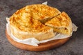 Switzerland food Walliser Cholera cake with potato, leek , apple, cheese closeup on the wooden board. Horizontal