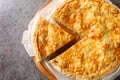 Switzerland food Walliser Cholera cake with potato, leek , apple, cheese closeup on the wooden board. Horizontal top view