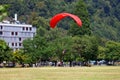 SWITZERLAND, INTERLAKEN, AUGUST 02, 2022 - Tourists paragliding in Interlaken, Bernese Oberland, Switzerland