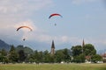 SWITZERLAND, INTERLAKEN, AUGUST 02, 2022 - Tourists paragliding in Interlaken, Bernese Oberland, Switzerland