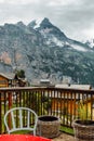 Switzerland, Jungfrau. Swiss Alps. Cozy traditional small village in mountains. Beautiful landscape. Terrace with table Royalty Free Stock Photo