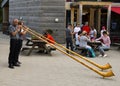 Switzerland lucerne Pilatus mountain and woman performing with a traditional alphorn or alpenhorn