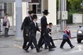 Switzerland: Orthodox jewish people walking across the street to