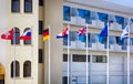 Switzerland, Russian, Netherlands, German, British, Greek, European Union Flags on flagpoles fluttering in the wind opposite the Royalty Free Stock Photo