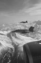 FA-18 military jets from Swiss Airforce escorting civil airplaine in the swiss alps