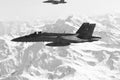 FA-18 military jets from Swiss Airforce escorting civil airplaine in the swiss alps