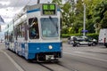Vintage blue tram on the move in the middle of Zurich