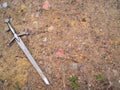 Sword on gravel dirt background