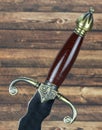 Sword handle on wooden background Royalty Free Stock Photo