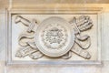 Sword and shield with arrows artistic element on the facade of an old building in Vienna, Austria