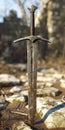 A sword that is sitting on a rock in the dirt Royalty Free Stock Photo