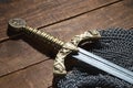 Sword and the soldier's helmet with horns on a wooden background Royalty Free Stock Photo