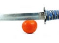 Sword and tomato Royalty Free Stock Photo