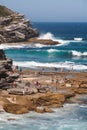 SYDNEY, AUSTRALIA - Dec 23, 2012: Crowds of tourists relaxing and sunbathing by a cliff in Tamarama beach