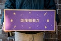 Delivery man holding Dinnerly meal kit in a box near the front door Royalty Free Stock Photo