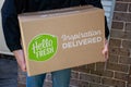 Sydney, Australia 2020-05-09 Delivery man holding Hello Fresh meal kits in a box