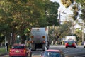 Garbage wheelie bins with colourful lids for recycling and general household waste lined up on the