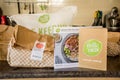 Hello Fresh meal kits packed in paper bags on a kitchen countertop