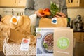 Sydney, Australia 2020-05-09 Hello Fresh meal kits packed in paper bags.Man`s hands holding vegetables