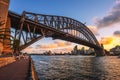 People walk under the Harbour Bridge with view of Sydney skyline Royalty Free Stock Photo