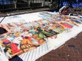 A street artist drawing on large piece of paper laid out on the floor at Sydney, Circular Quay.