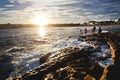 SYDNEY, AUSTRALIA - Mar 21, 2012: People at north bondi rocks in the beautiful sunlight of a summer sunset, Bondi beach