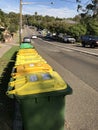 Sydney, Australia May 2020 Australian garbage wheelie bins with yellow lids for recycling household waste lined up on the street