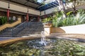 Running water from a fountain, tucked in a quiet corner of a modern building block