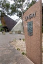 Vertical marble slab with UNSW script and emblem at the Chancellery UNSW