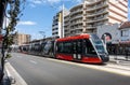 Sydney Light Rail carriages stop at Kingsford Station, Anzac Parade