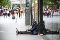 Australian aboriginal man homeless sitting on the ground at Sydney downtown.