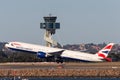 British Airways Boeing 777 large commercial airliner taking off in front of the control tower at Sydney Airport