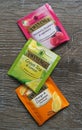 Twinings three Tea Bag varieties green, fruity and spicy on wooden surface.