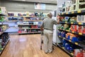 A senior man wearing mask surveying grocery aisle at ALDI supermarket during coronavirus pandemic