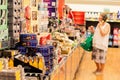 Selective focus image of a senior woman surveying special buys aisle at ALDI supermarket