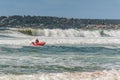 Surf rescue life savers training in progress. Surf rescue boat floating on the waves at Wanda Beach, Royalty Free Stock Photo