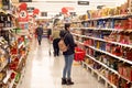 Teenage girl man wearing mask surveying grocery aisle at Coles supermarket during COVID-19 Delta