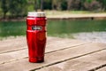 Thermos 470ml Insulated Reusable Stainless Steel travel tumbler mug on the table with nature