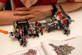 Man assembling piece of complex machinery from plastic construction kit parts details